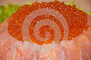 Caviar with red fish - seed or trout on green lettuce salad as side dish. healthy food and culinary. cuisisne. dieting and eating.