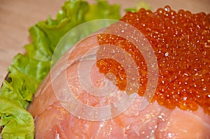 Caviar with red fish - seed or trout on green lettuce salad as side dish. healthy food and culinary. cuisisne. dieting and eating.