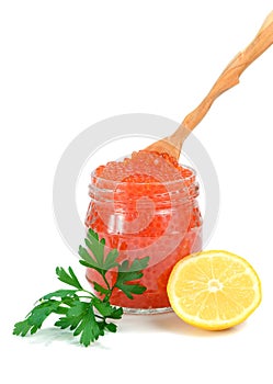 Caviar red in a glass jar with lemon and parsley