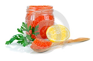 Caviar red in a glass jar with lemon and parsley