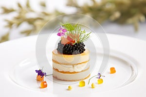 caviar on a small blini with cream and chives