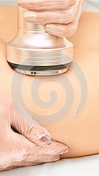 Cavitation machine therapy. Woman body lipo treatment. Ultrasound salon device. Radio frequency cosmetology procedure