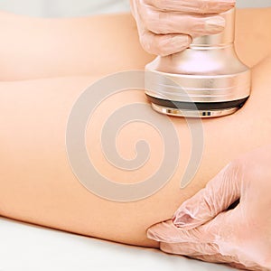 Cavitation machine therapy. Woman body lipo treatment. Ultrasound salon device. Radio frequency cosmetology procedure