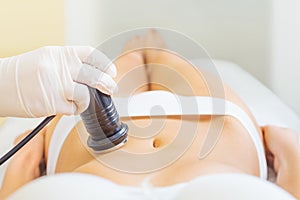 Cavitation treatment with young woman photo