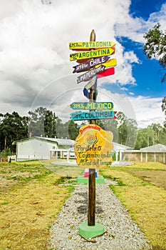 CAYAMBE, ECUADOR - SEPTEMBER 05, 2017: Informative sign of distance from Cayambe, of different countries written over a