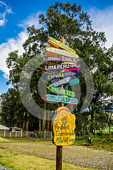 CAYAMBE, ECUADOR - SEPTEMBER 05, 2017: Informative sign of distance from Cayambe, of different countries written over a