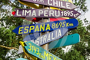 CAYAMBE, ECUADOR - SEPTEMBER 05, 2017: Informative sign of distance from Cayambe, of different countries written over a