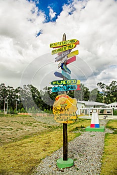 CAYAMBE, ECUADOR - SEPTEMBER 05, 2017: Informative sign of distance from Cayambe, of different countries written over a