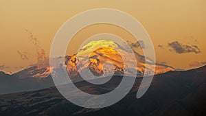 Cayambe volcano under a burning sunset and clear sky