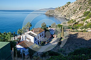 CaÃ±uelo de Nerja beach seen from above with a house and the watchtower in the background. Maro Cerro Gordo Cliffs