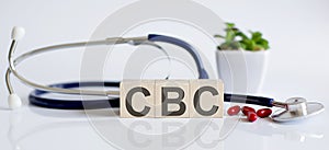 CBC the word is written on the wooden cubes and sthetoscope and piils . Medical concept