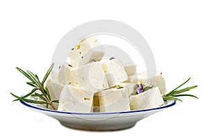 cbes of Feta cheese isolated on white background clipping Heap of Feta cheese, basil leaves and tomatoes.