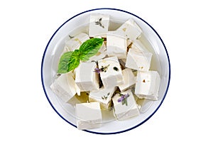 cbes of Feta cheese isolated on white background clipping Heap of Feta cheese, basil leaves and tomatoes.