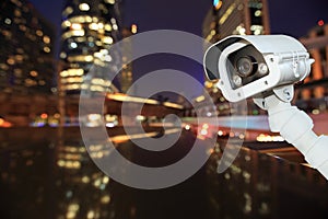 CCTV with bokeh blurring city in night background.