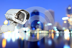 CCTV with bokeh blurring city in night background. photo