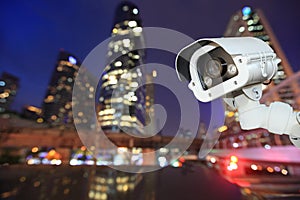 CCTV with bokeh blurring city in night background.