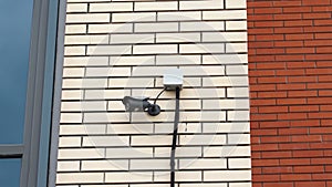 CCTV camera installed on the brick wall of the building