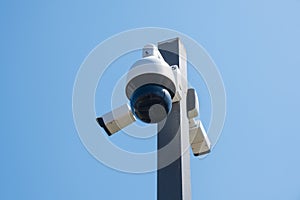 CCTV camera monitoring system with panoramic view outdoor against blue sky. Safety system. Technology concept