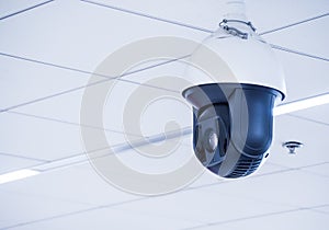 Cctv camera mounted on the ceiling in the office building