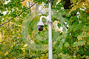 CCTV camera on a pole in the park. system of protection