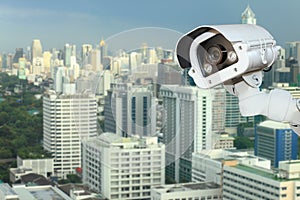 CCTV camera security with blurring city background .