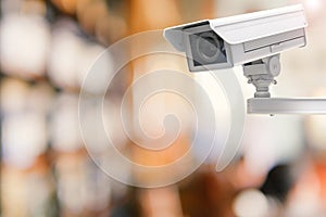 Cctv camera or security camera on retail shop blurred background