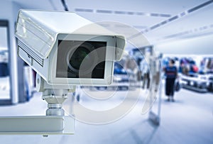 Cctv camera or security camera on retail shop blurred background photo