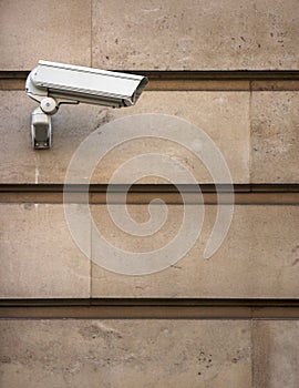 CCTV camera on stone-clad wall