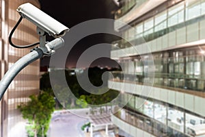 CCTV camera or surveillance operating with glass building in background