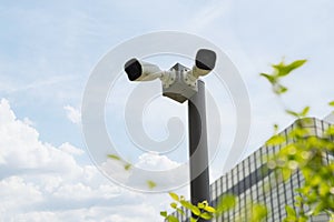 CCTV camera, Two high-definition security cameras are mounted on a pole in front of a bank