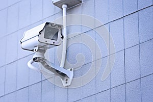 CCTV camera on the wall high building.