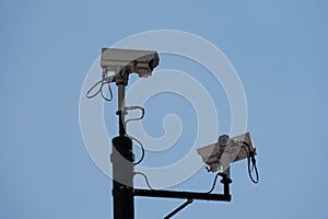 CCTV cameras against a bright blue sky