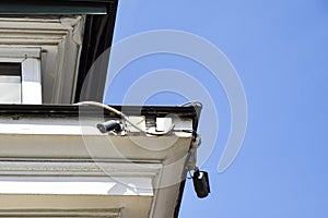 CCTV cameras on the corner of the facade of a multi-storey building