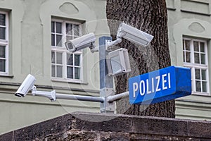 CCTV cameras on display next to a police station with a police sign in German: Polizei in the Bavarian city of Munich. photo
