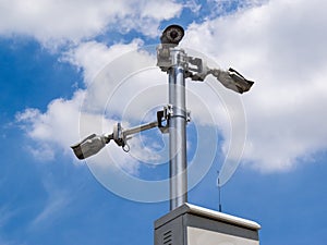 CCTV cameras on metal pole in public place