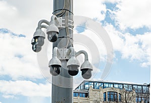 CCTV cameras on one mast against a blue cloudy sky. City CCTV