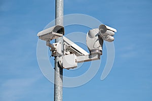 CCTV cameras on the pillar against the blue sky.