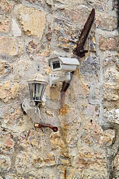 CCTV security camera on the ancient stone wall