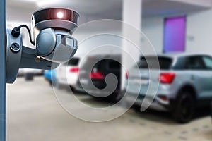 CCTV security camera on blur car parking. Copy space.