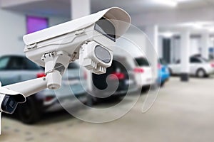 CCTV security camera on blur car parking. Copy space.