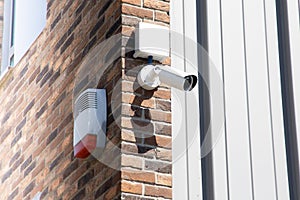 CCTV Security camera at building in city with brick wall background in Technology concept