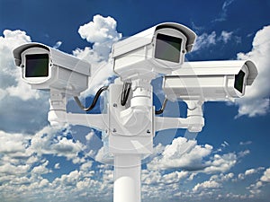 CCTV security camera on cloud sky background.