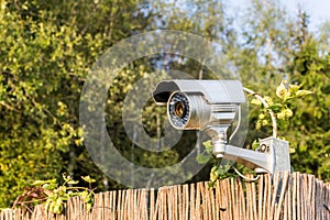 CCTV security camera on garden fence