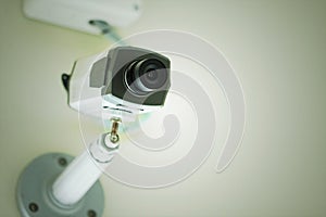 CCTV or Security camera installed on white ceiling