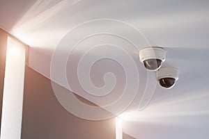 CCTV security camera mounted on a white ceiling.