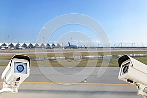 CCTV Security Camera operating in airport runway background.