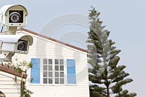 CCTV Security Camera operating on backyard roofing house.