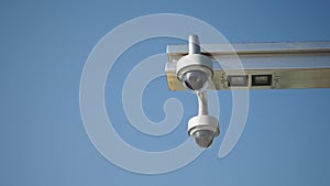 CCTV security camera operating at metro station against blue sky