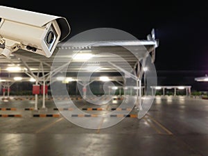 CCTV Security Camera operating in parking lot car.