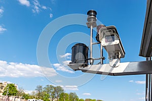 CCTV Security camera over blue sky background. - Image